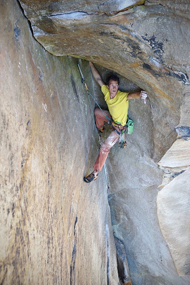 Angus Kille about to commit to underclinging his way from under the roof of Doppler Effect (5.10b), Eastern Sky Bridge. © Ray Wood