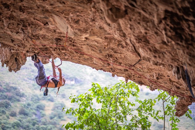 Emilie onsighting the Travel Diaries (8a+) in Shigu, China. Photo by Julian Reinhold